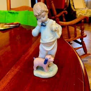 Little boy on phone with puppies, lladro figure